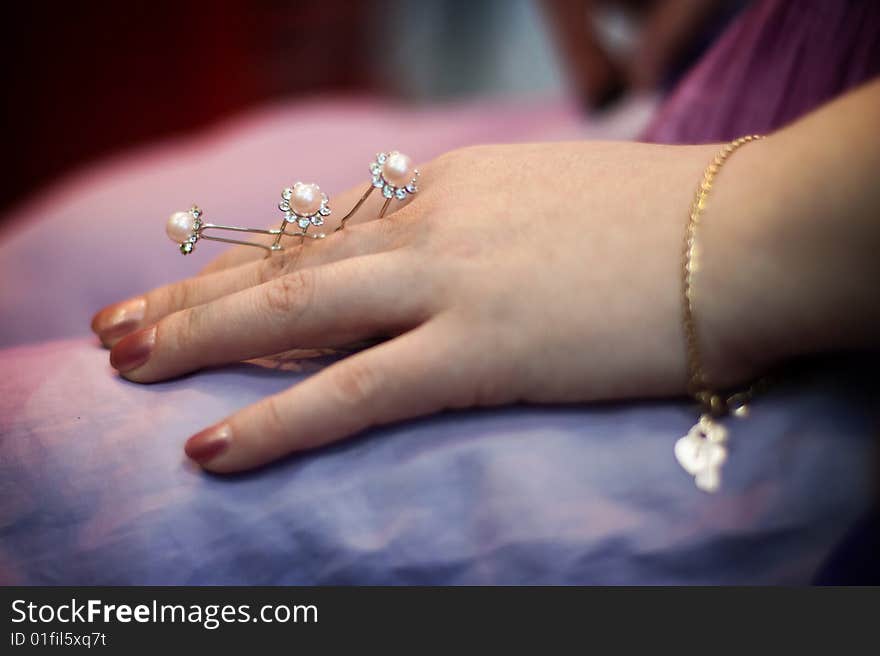 Three hairpins for hair in a hand of the woman. Three hairpins for hair in a hand of the woman