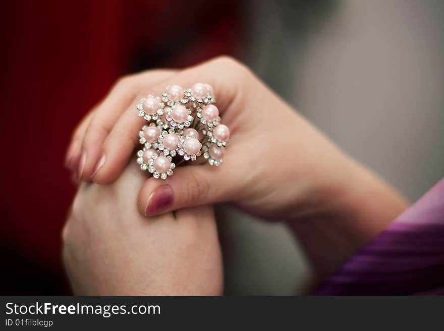 It is a lot of hairpins for hair in a hand of the woman. It is a lot of hairpins for hair in a hand of the woman