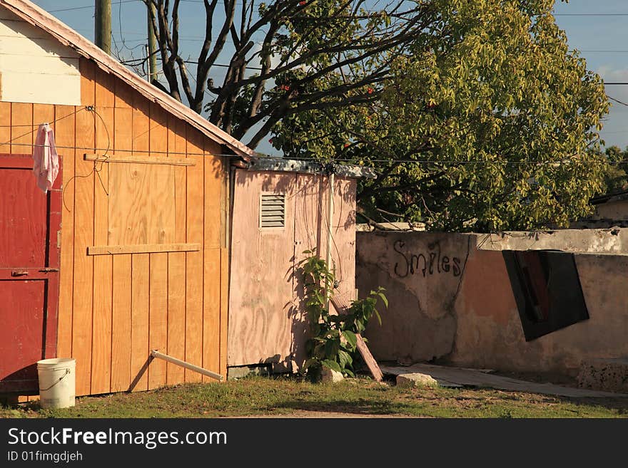 Bright colored  poor  home on tropical island resort with grafitti. Bright colored  poor  home on tropical island resort with grafitti