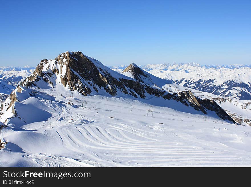 Austria. Mountains. The Alpes.Tops of mountains in a snow and the bright dark blue sky.