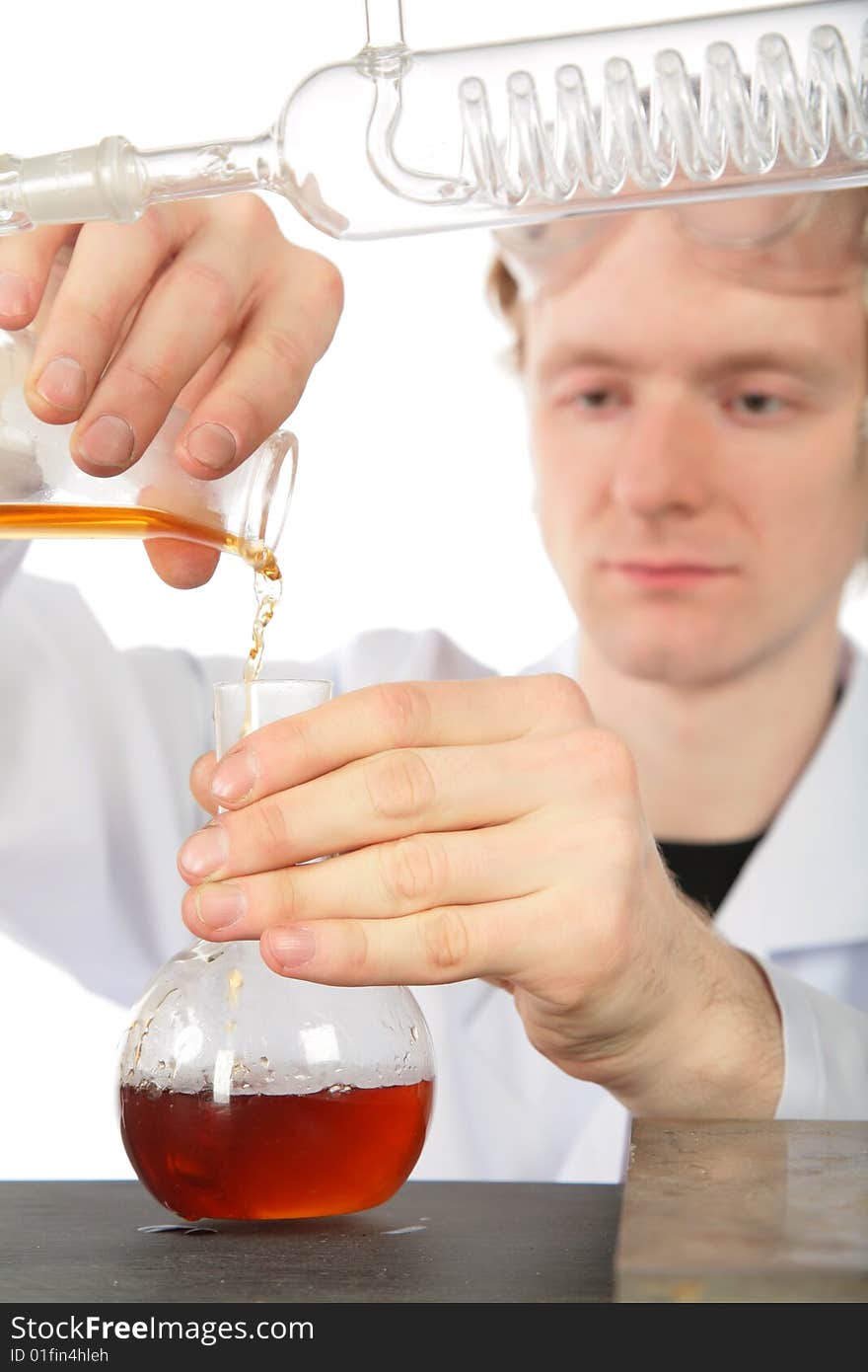 Chemist Pours  Brown Liquid In Flask