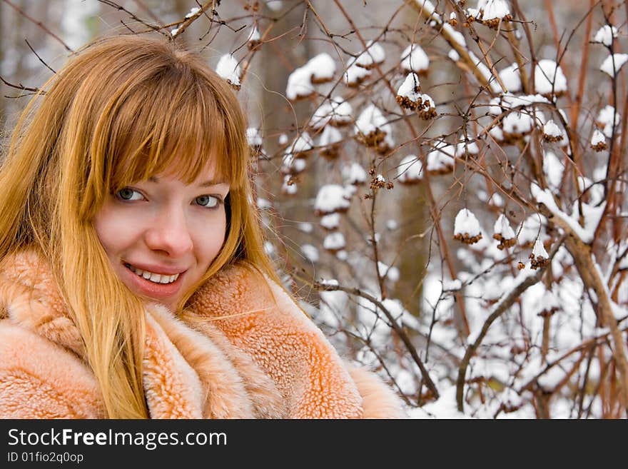 Red-heared girl in fur coat outdoors - shallow DOF. Red-heared girl in fur coat outdoors - shallow DOF