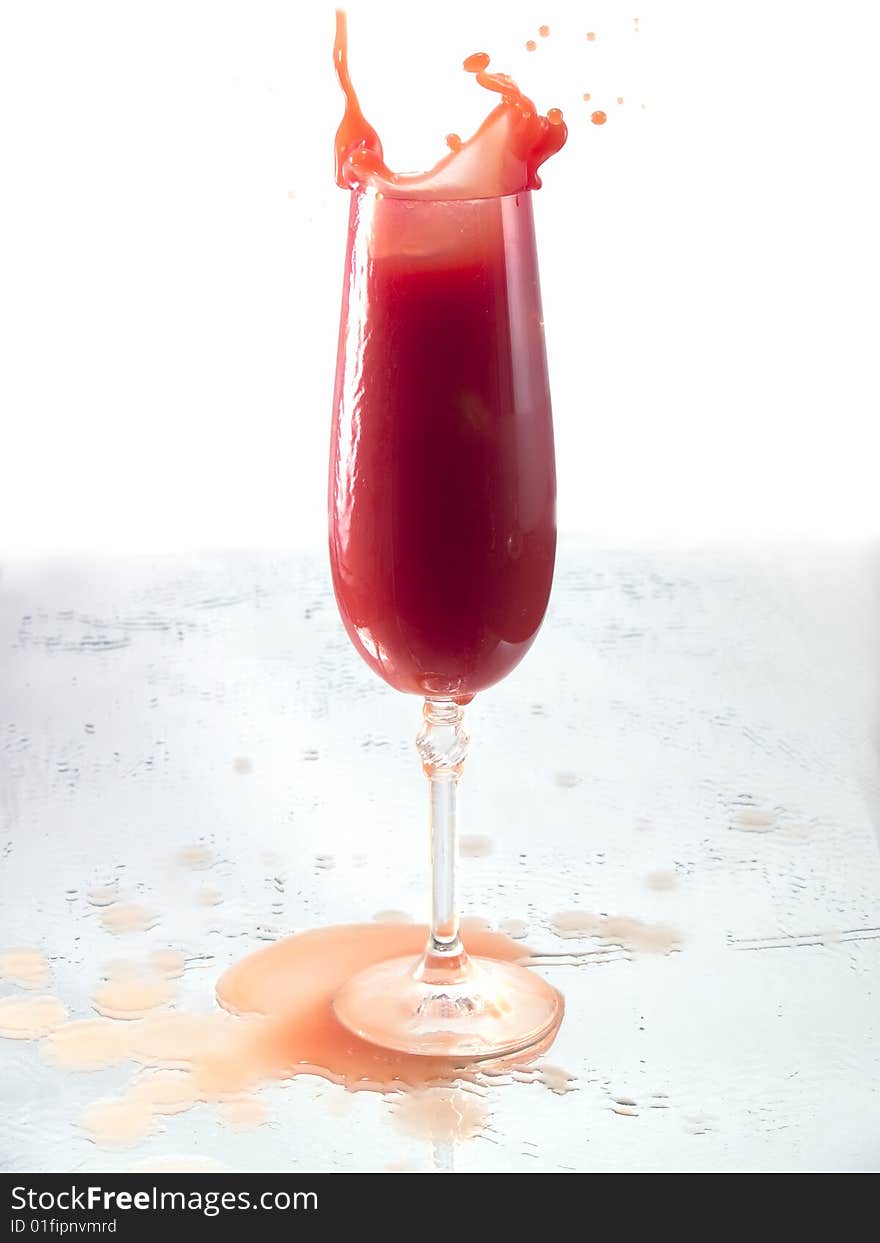 Tomato juice splash in glass white background