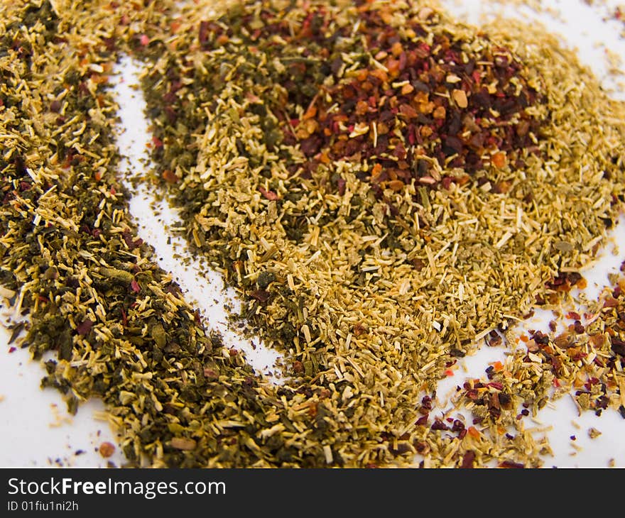 Tea heart shaped of three different types of ground tea leaves (green tea, chamomile tea and hibiscus tea), colorful *suitable for abstract love and Valentine cards and greetings **RAW format available