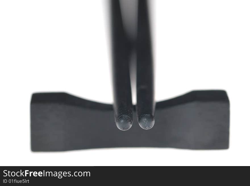 Black chopsticks isolated on the white background. Narrow depth of field. Black chopsticks isolated on the white background. Narrow depth of field.