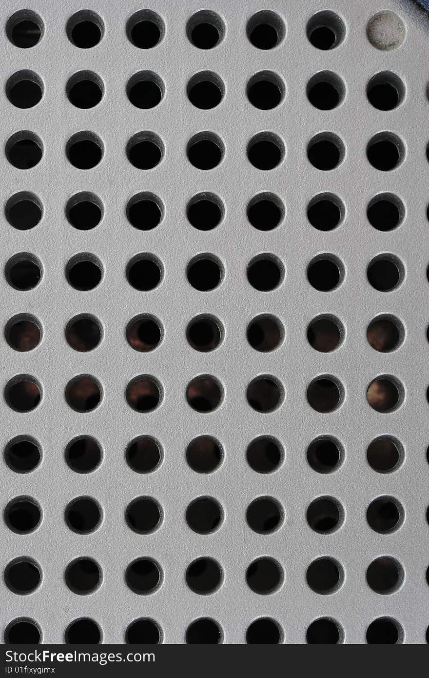 Plastic grille with round holes on the black background. Plastic grille with round holes on the black background.