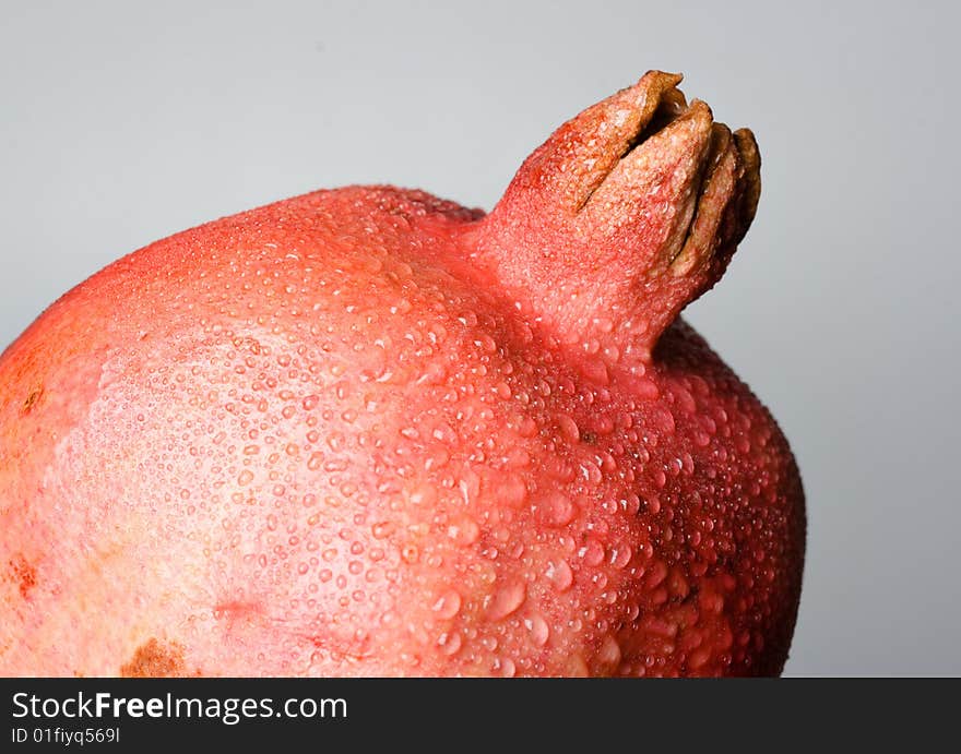 Pomegranate fruit with water drops.