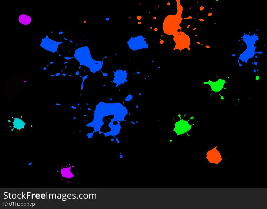 Color ink splatters isolated on black background