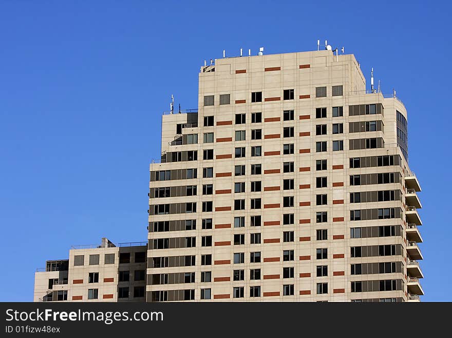 View of modern high rise building comprised of hotel space, stores, and condominiums. View of modern high rise building comprised of hotel space, stores, and condominiums