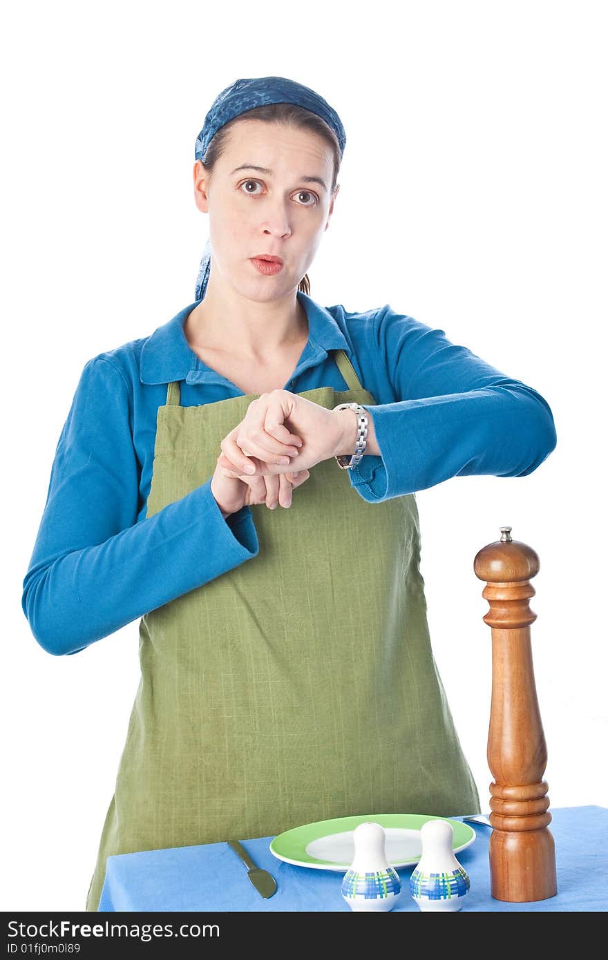 A woman in a domestic role looking at her watch and not happy. A woman in a domestic role looking at her watch and not happy.