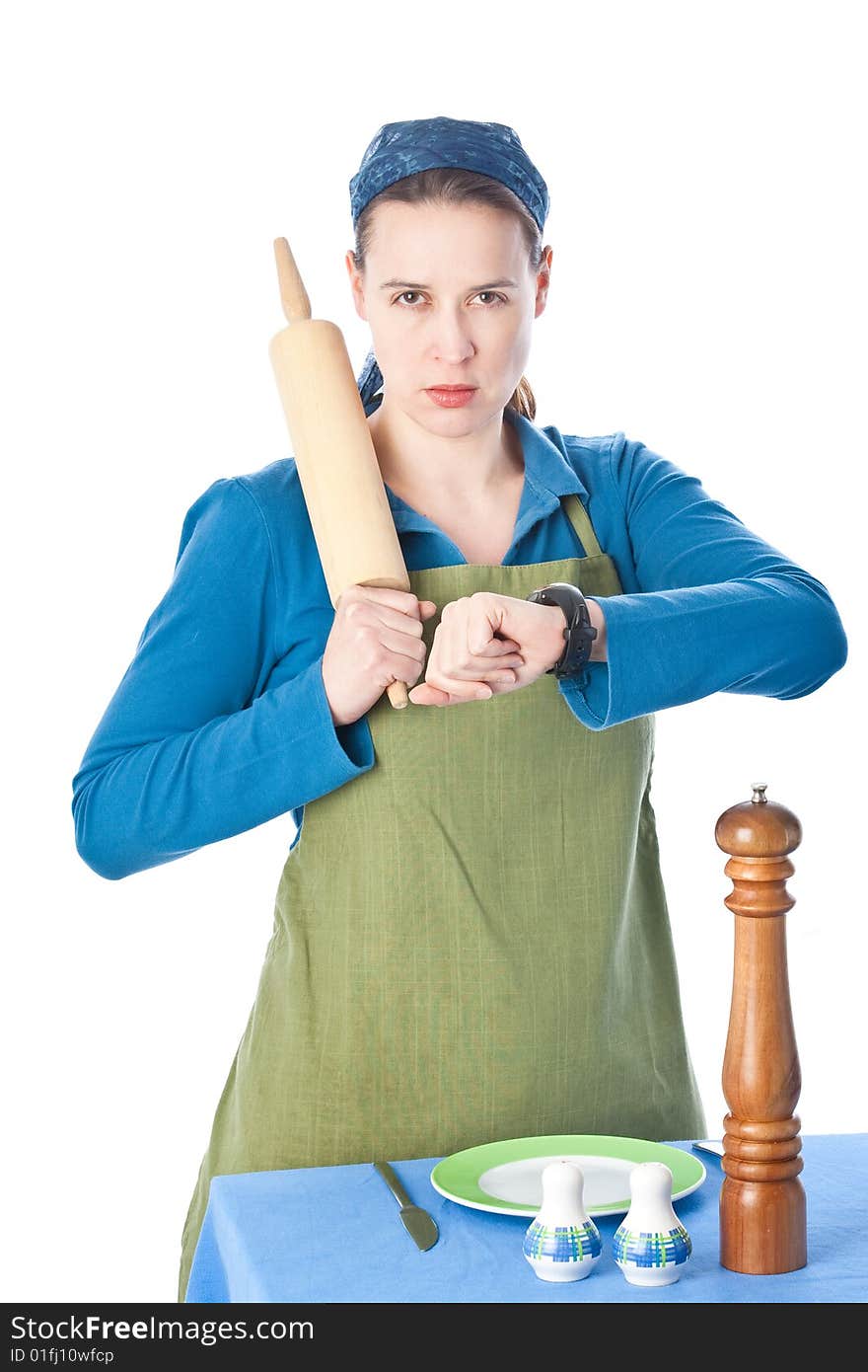 A woman in a domestic role upset and holding a rolling pin. A woman in a domestic role upset and holding a rolling pin.