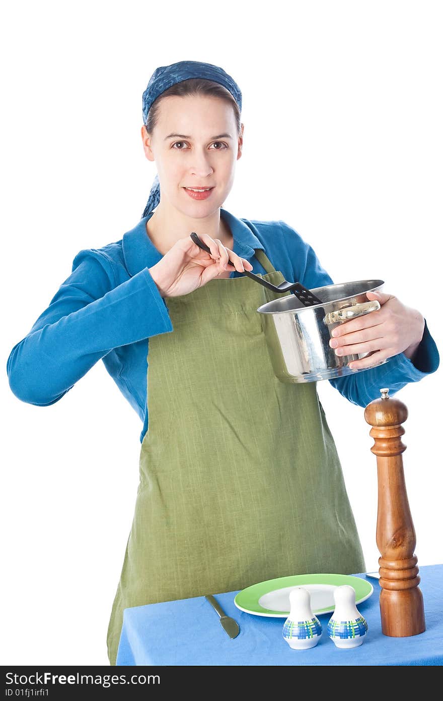 A woman in a domestiuc role serving a meal. A woman in a domestiuc role serving a meal