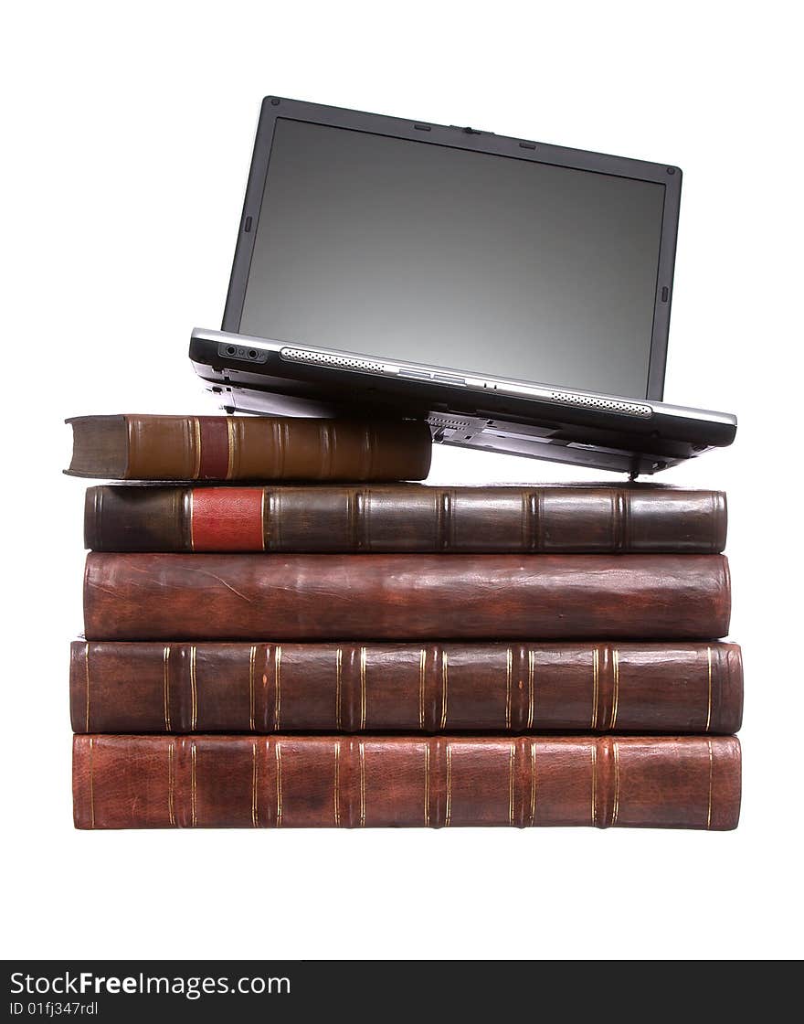 Old leather bound books with a laptop isolated on a white background