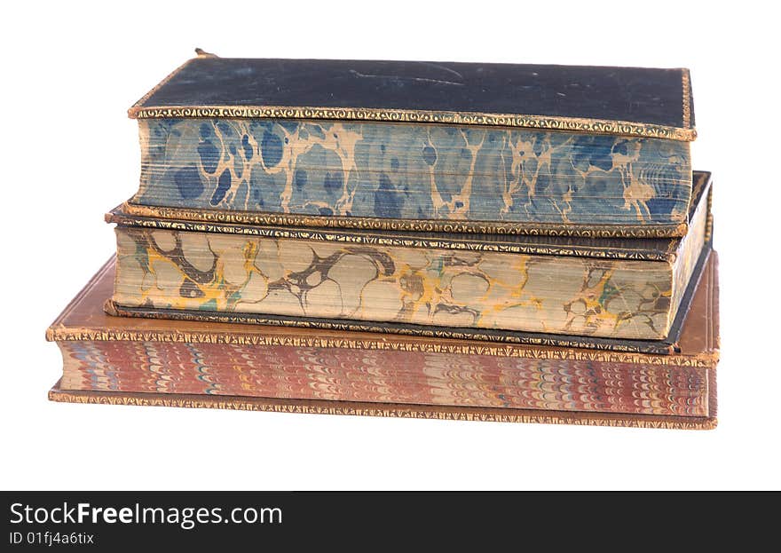 A pile of old leather bound books isolated on a white background