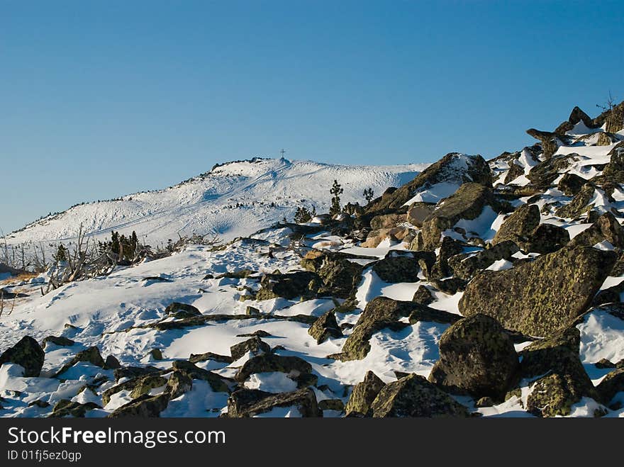 Stones on background of mountain with holy cross. Stones on background of mountain with holy cross