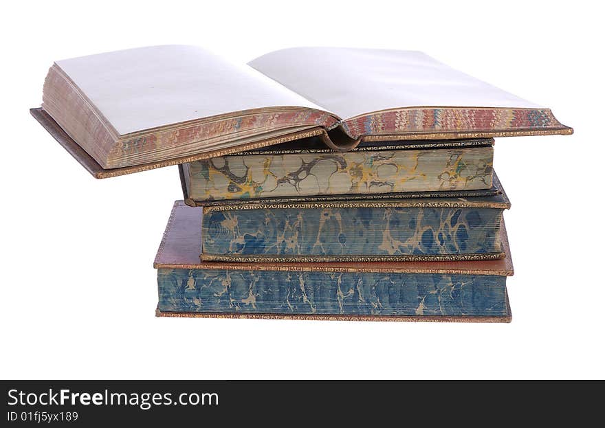 A pile of old leather bound books isolated on a white background