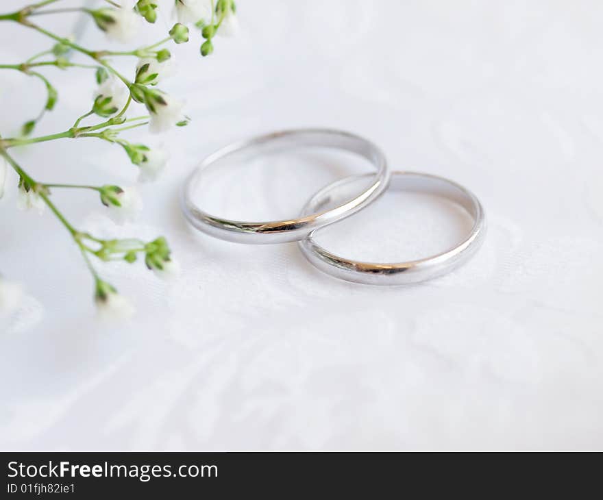 Closeup of wedding rings on a white textile