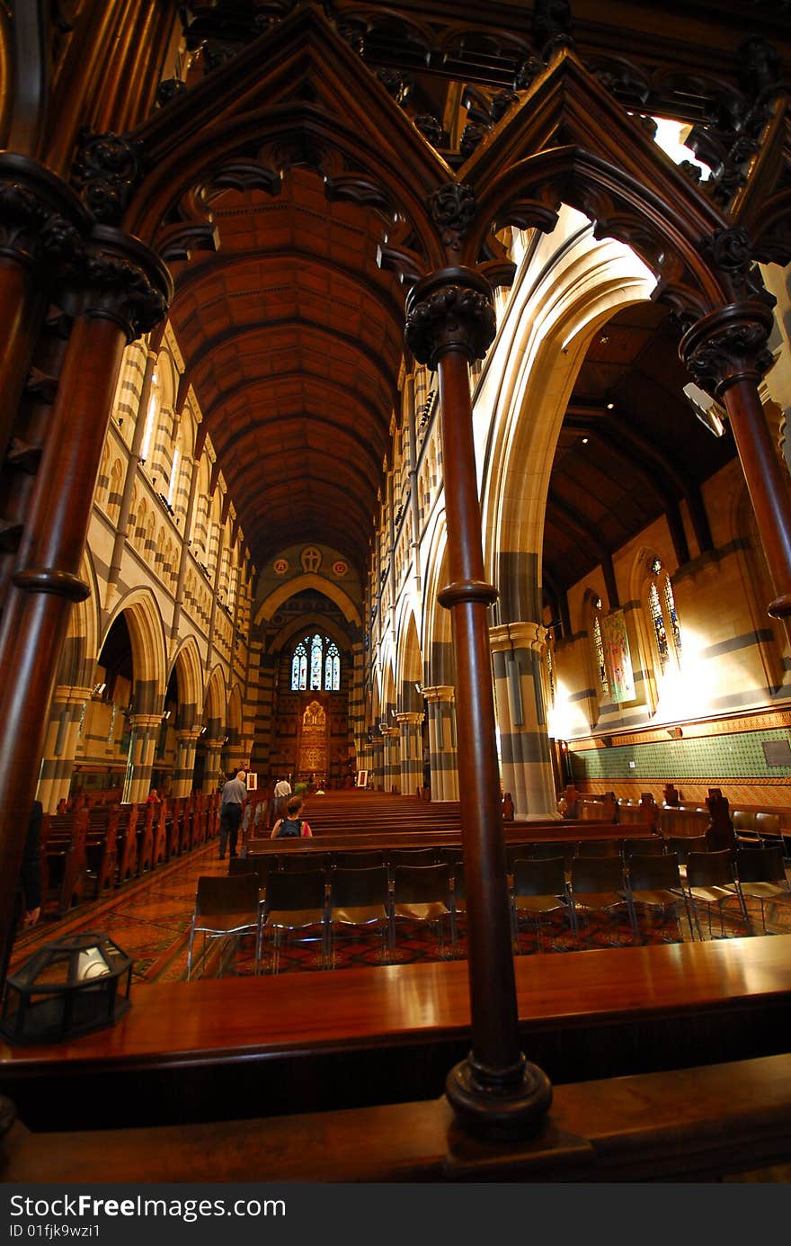 Church interior showing wooden arches and tall ceiling