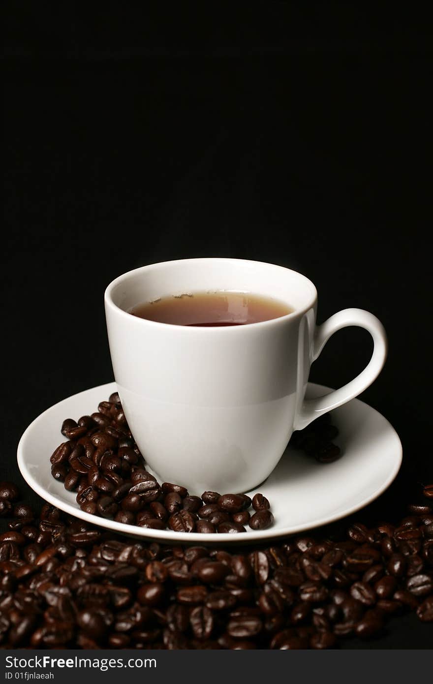 White Coffee cup and coffee beans on white  background with space for text. White Coffee cup and coffee beans on white  background with space for text