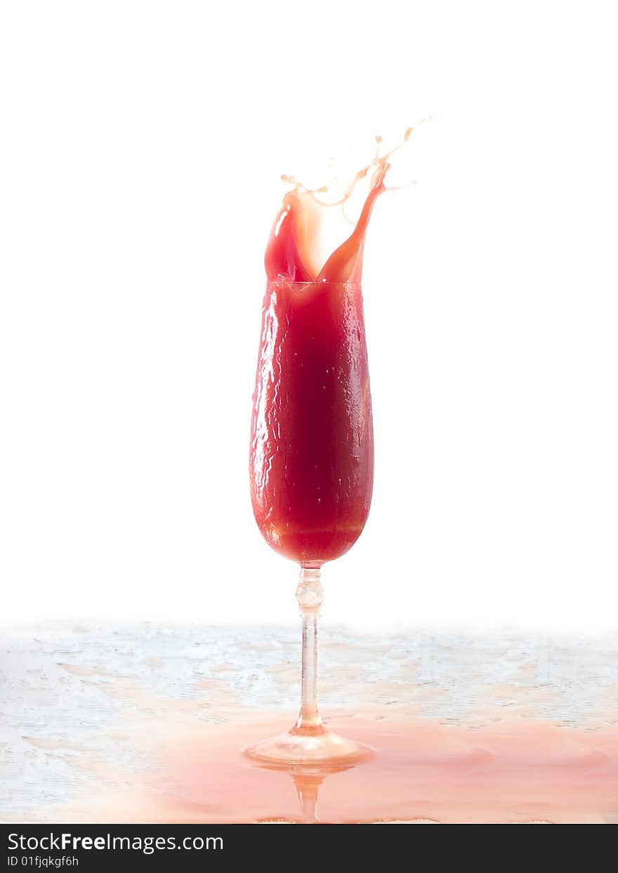 Tomato juice splash in glass white background