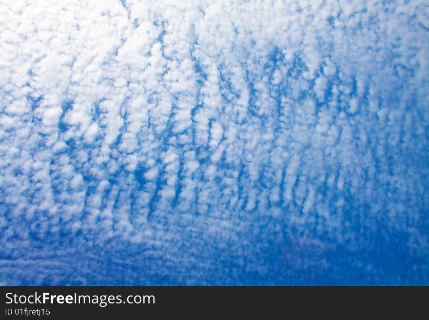 Blue cloudy sky on a warm sunny day