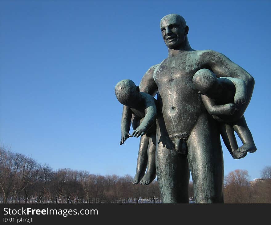 Sculpure of man with kids, Vigeland sculpture park Oslo, Norway.