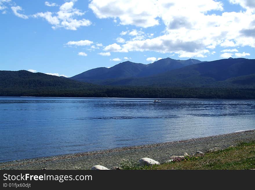 Scenic photo of a Lake with mountains in the background somewhere in New Zealand