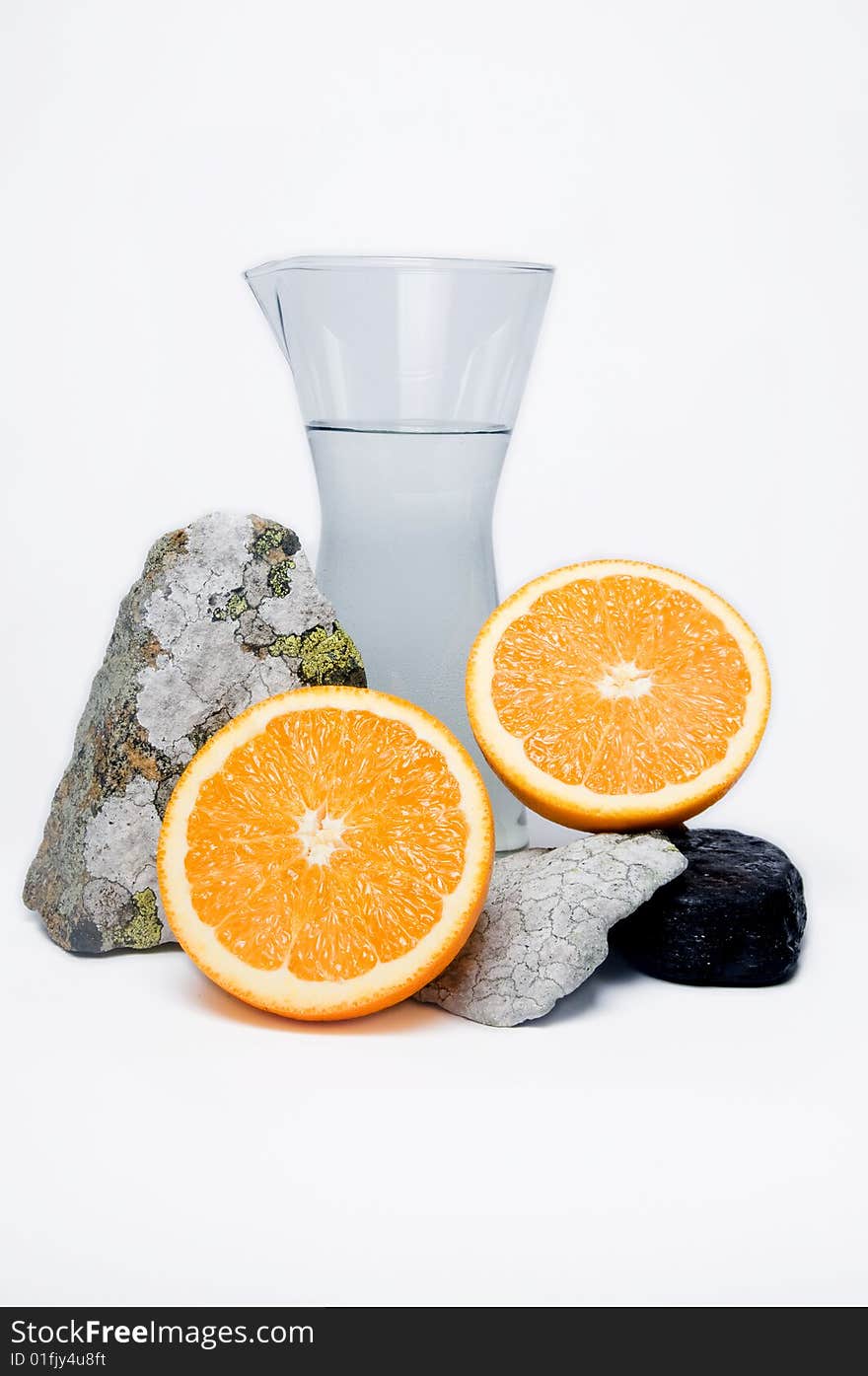 Still life of water, stones and oranges