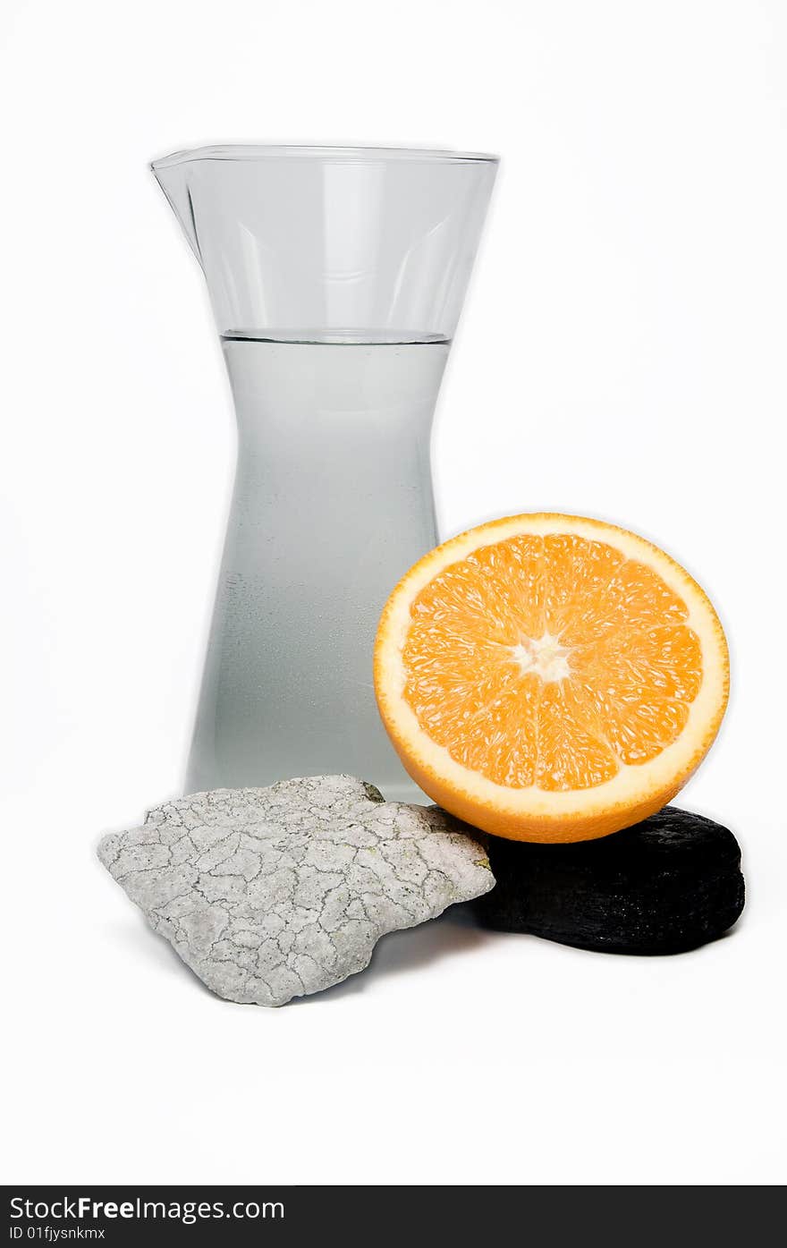 Still life of water, stones and oranges