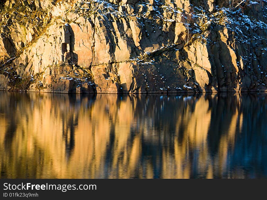 Rock and their reflection in the water in winter setting (Sweden). Rock and their reflection in the water in winter setting (Sweden)