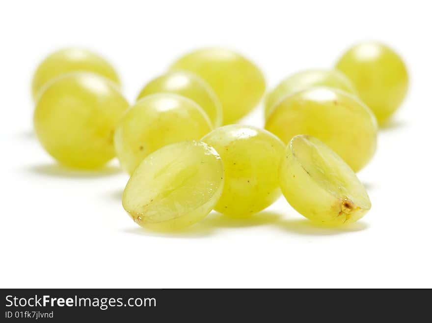 Several grape berries isolated on a white background.