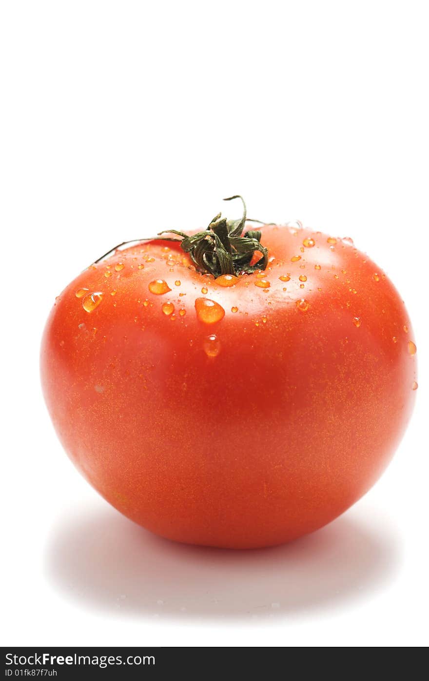 Tomato with drop isolated on a white background.