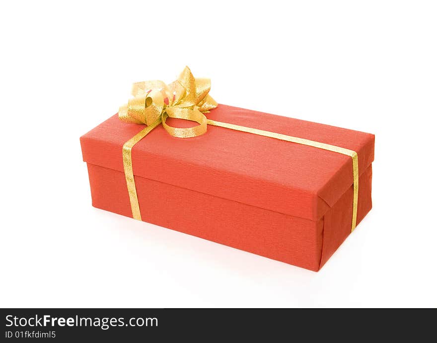 Red gift box over white background with gold ribbon