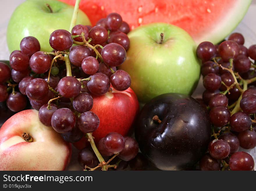 Apples, watermelon, peaches, plums and grapes. Apples, watermelon, peaches, plums and grapes