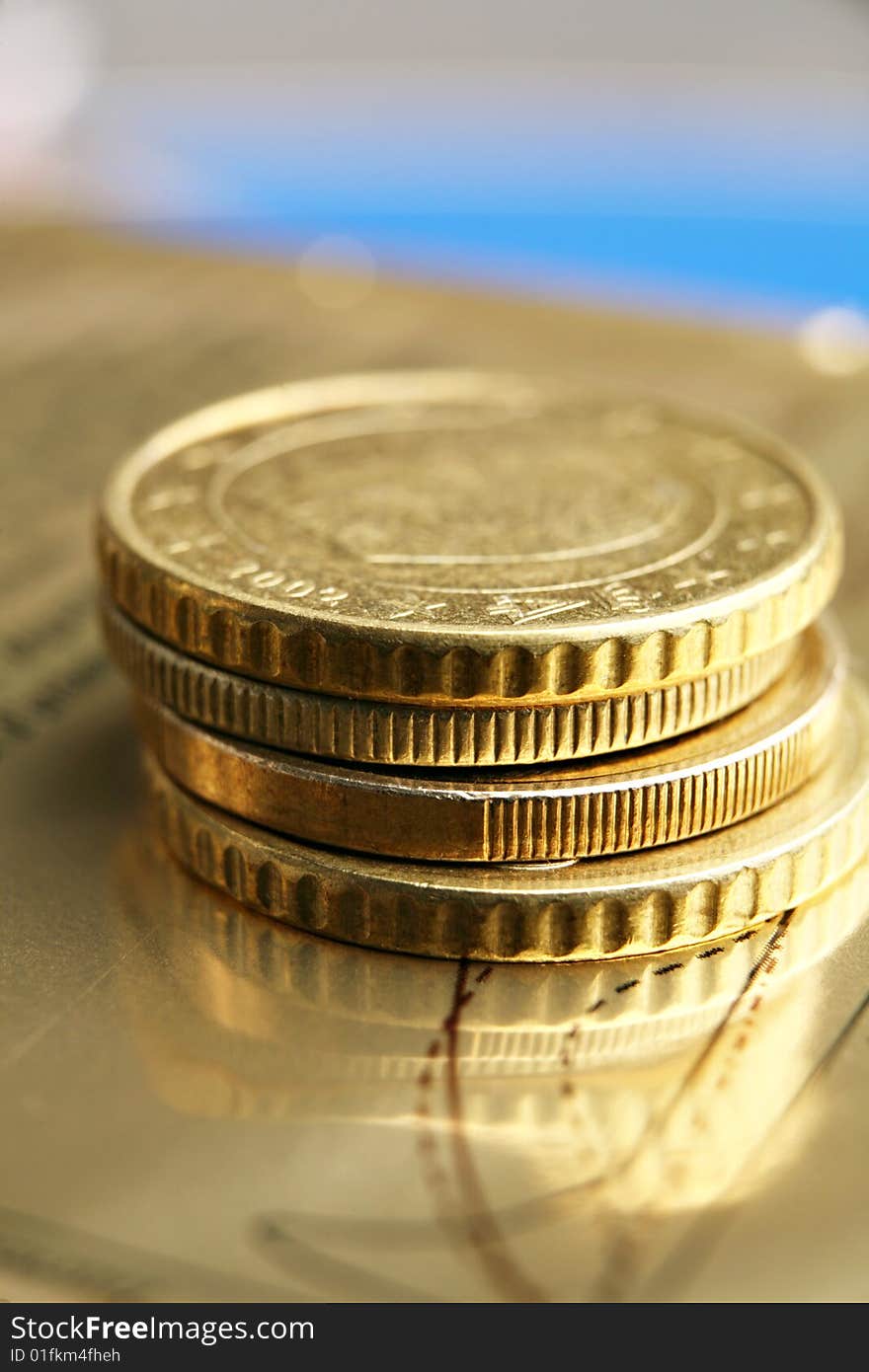 Pile of euro coins on golden background.