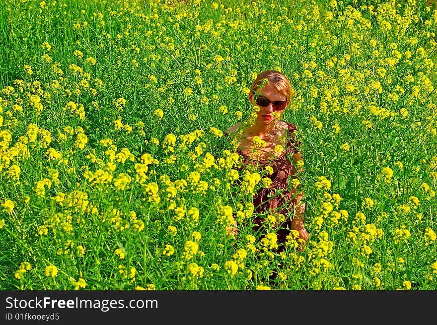 Woman in the yellow flowers field