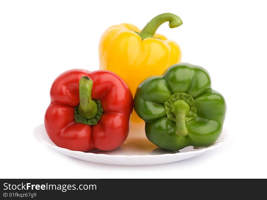 Three colorful peppers on the plate