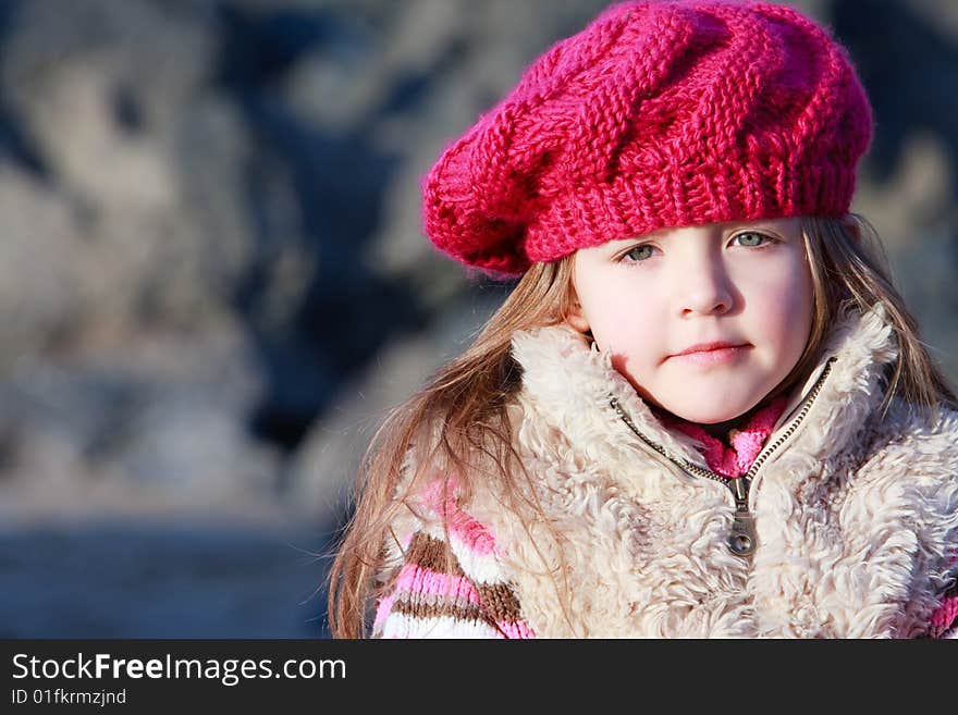 Young girl on the beach alone during Autumn in England