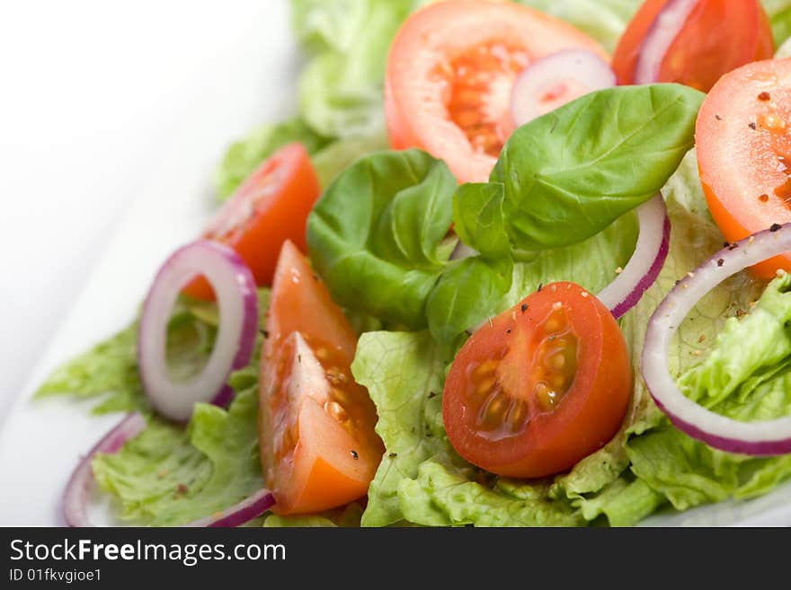 Healthy salad with lettuce, tomato, onion