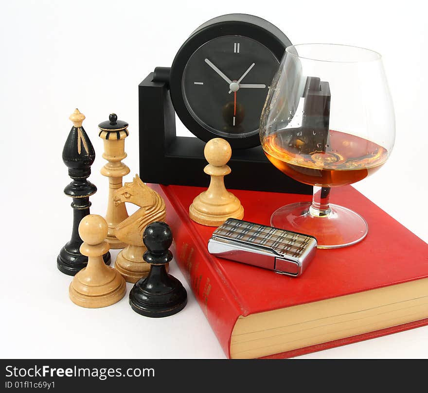 A good book, a glass of cognac , chess and watch. A good book, a glass of cognac , chess and watch