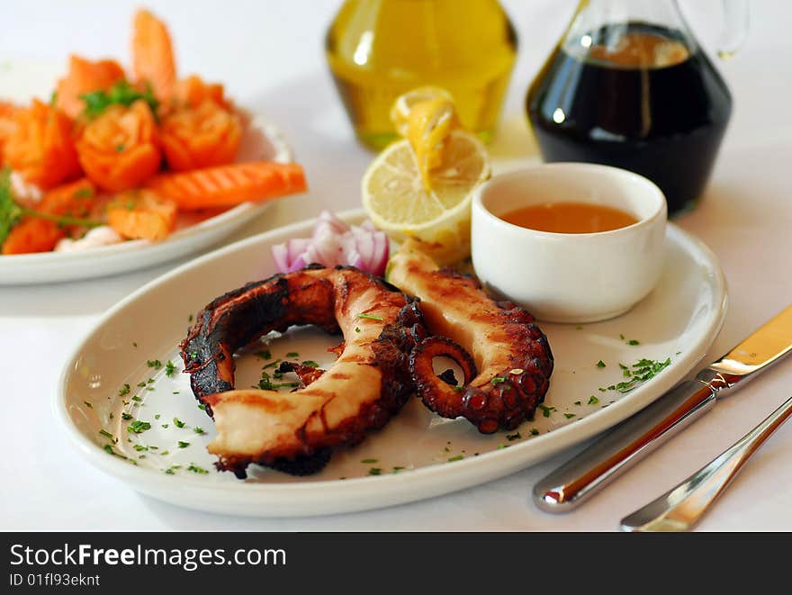 Grilled octopus olive oil and vinegar on the dinner table,traditional turkish seafood