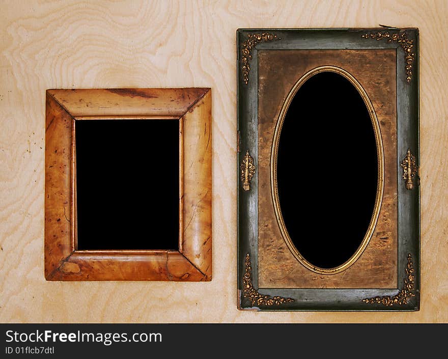 Empty wintage photo-frames on wooden wall