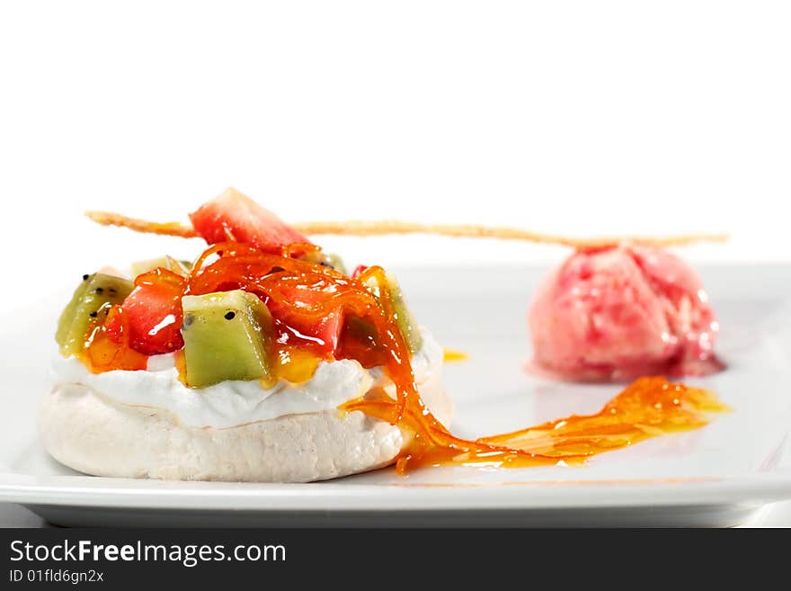 Meringue with Cream and Fresh Berries and Fruit with Strawberry Sorbet. Isolated on White Background. Meringue with Cream and Fresh Berries and Fruit with Strawberry Sorbet. Isolated on White Background