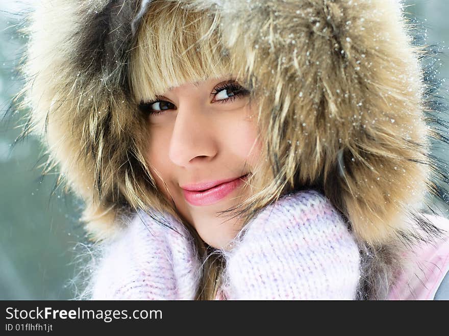 Portrait of a beautiful young smiling woman having a walk in the winter park. Portrait of a beautiful young smiling woman having a walk in the winter park