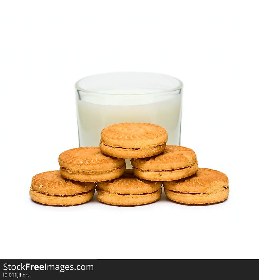 Glass with milk and cakes on plate isolated on white