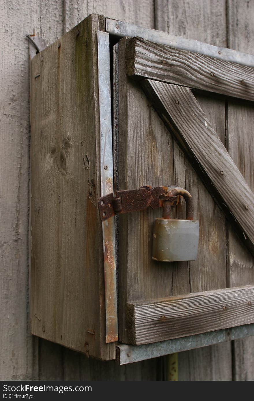 Old damaged wooden box with a metal padlock. Old damaged wooden box with a metal padlock