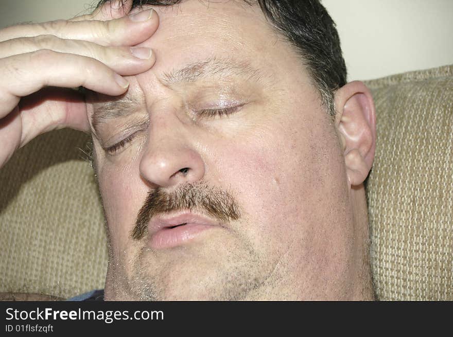 Man suffering from a powerful migraine headache.