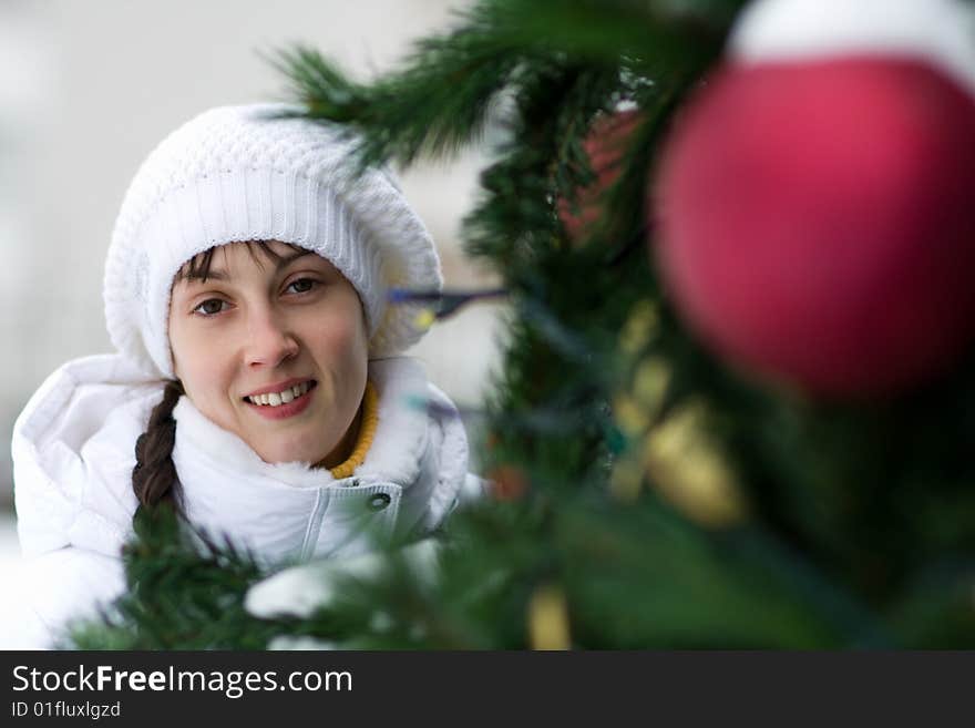 Smiling girl near christmas tree - shallow DOF