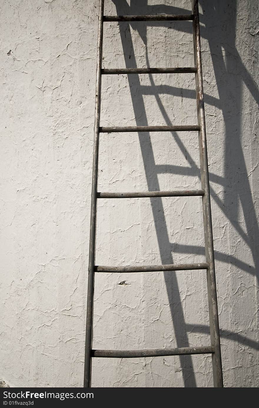 Steps on a blanc wall in sun light