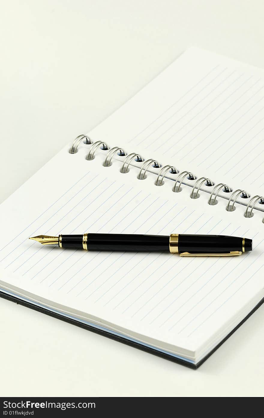 Blank notebook with a fountain pen kept on top. Blank notebook with a fountain pen kept on top